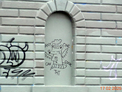 photograph of black graffiti on the lincoln reservoir gatehouse depicting a tearful angel-winged rat wearing a chef's toque surrounded by the words 'anyone can cook' and 't4t'