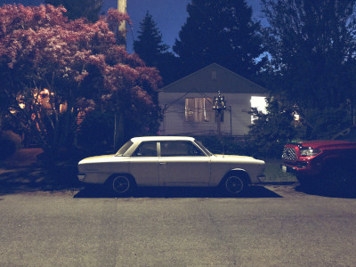 an old white car at night in ballard under a streetlight